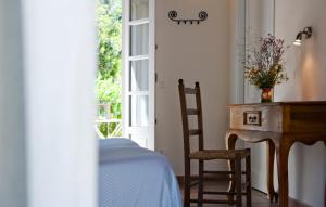 een slaapkamer met een tafel en een bureau en een tafel en stoel bij Hotel Santo Stefano in Portoferraio