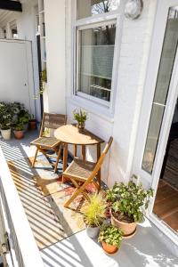 a patio with a table and chairs and potted plants at Gorgeous And Stylish Place For Two In Hip West! in Amsterdam