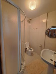 a bathroom with a shower and a toilet and a sink at Piso da Playa in Laxe +5 photos