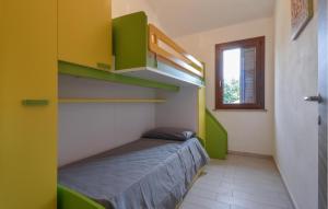 a small room with a bed with green shelves at Secca 3 in Costa Rei