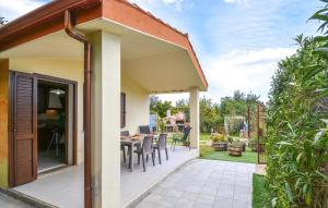 a home with a patio with a table and chairs at Secca 3 in Costa Rei