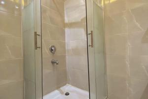 a shower with a glass door in a bathroom at Luxury 3 bedroom Apartment with a great Seaview* in Abū Qīr +4 photos