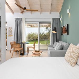 a bedroom with a bed and a living room at The OliveStone Village - Yoga Retreat Paradise in Ágios Márkos