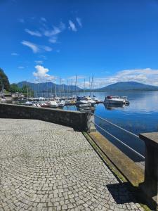 a dock with boats in a marina on the water at Lake View in Meina