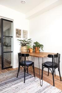 a dining room table with black chairs and plants at Gorgeous And Stylish Place For Two In Hip West! in Amsterdam +14 photos