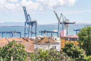a view of a city with cranes in the water at Beato Riverside Cozy Apartments in Lisbon
