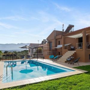 a swimming pool in front of a house at Villa Roula 3BR Seaview Villa in Chania in Stérnai