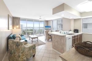 a kitchen and living room with a view of the ocean at Destin West Sandpiper Bld 501 Bay side Condo in Fort Walton Beach