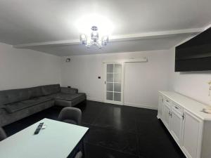a living room with a couch and a table at Apartament cu gradina central in Iaşi
