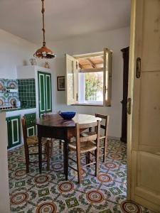 a kitchen with a table and chairs in a room at Villa Belvedere in Lipari
