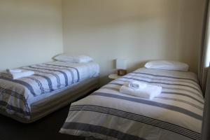 two beds sitting next to each other in a room at Totara Cottage in Lake Tekapo