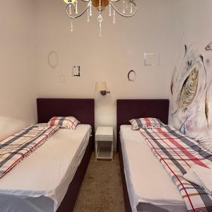 two beds sitting next to each other in a room at Apartments Lungo Mare in Sveti Stefan