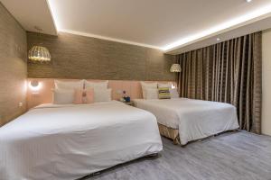 Postel nebo postele na pokoji v ubytování 里萊行旅 - Lilai Motel
