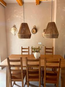 a dining room with a wooden table and chairs at Kalpic Suites & Villa in Lozovac