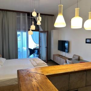 a bedroom with a bed and pendant lights at Apartments Lungo Mare in Sveti Stefan