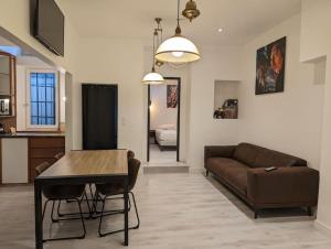 a living room with a couch and a table at R'Apparts T3 Industrial Spirit in Grenoble