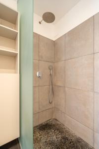 a bathroom with a shower with a glass door at Family private house in Dubulti, Jurmala, 400m to the beach in Jūrmala