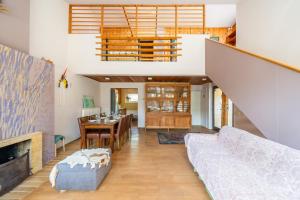 a living room with a staircase and a dining room at Family private house in Dubulti, Jurmala, 400m to the beach in Jūrmala