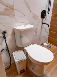 a bathroom with a white toilet and a shower at Appartement Bali (Asie) in Cotonou