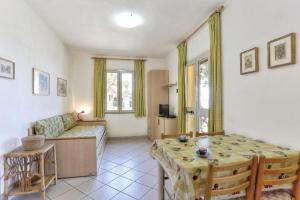 a living room with a table and a couch at Casa Ilva - Colle Paradiso Experience in Capoliveri