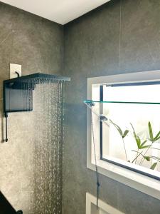 a shower with a shower head in a bathroom at Pousada Rainha Dos Lagos in Capitólio
