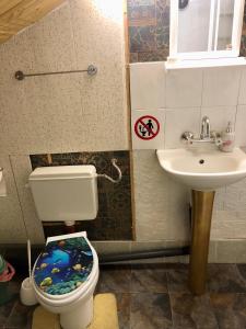 a bathroom with a toilet and a sink at Guest House Niya in Beli Iskar