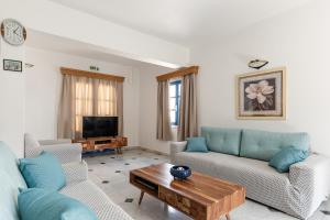 a living room with two couches and a coffee table at Hotel Francesca in Agios Prokopios