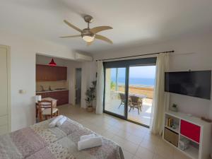 a bedroom with a bed and a view of the ocean at Portela Apartments Kastri in Keratokampos