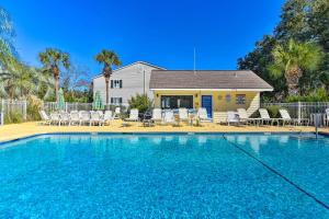 a swimming pool in front of a house at Condo with Amazing Amenities 1 Mi to Beach! in Mallory Park