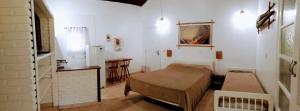 a room with a bed and a table in it at Residencial Canto da Praia - Jureia in Juréia