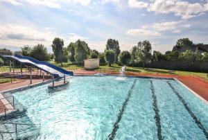 a pool with a slide and a water slide at Pension Malchin in Malchin