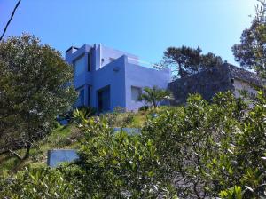 a white house on top of a hill with trees at Casa Mar in Punta del Este
