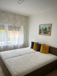 En eller flere senge i et værelse på Holyday Relax Home