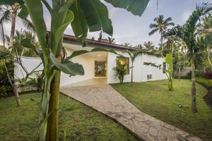 a courtyard of a house with palm trees at The Melaya Villas in Penginuman