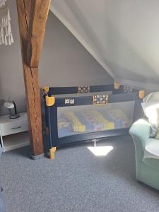 a childs bedroom with a bunk bed and a chair at Ferienwohnung Heinel in Bad Sulza +14 photos