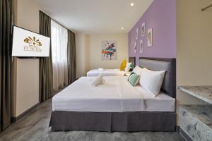 Postel nebo postele na pokoji v ubytování PJ De Inn Hotel