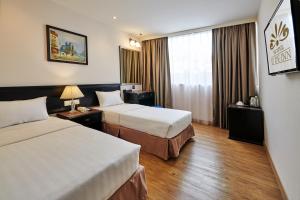 Postel nebo postele na pokoji v ubytování PJ De Inn Hotel