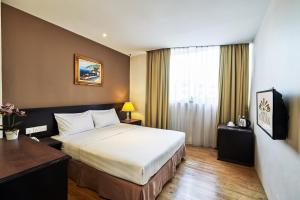 Postel nebo postele na pokoji v ubytování PJ De Inn Hotel