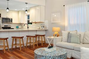 a living room with a couch and a kitchen at The Surf Ranch by Pristine Properties Vacation Rentals in Port Saint Joe +61 photos