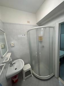 a bathroom with a shower and a sink at Hotel Massimo in Riccione