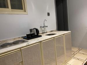 a kitchen with a counter top with a sink at كيان ألين in Abha