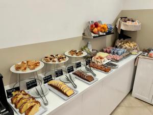 a buffet line with different types of bread and pastries at Hotel Massimo in Riccione