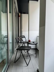 a chair and a table on a balcony at Modern Luxury Loft Porta Nuova - Parcheggio Privato in Turin