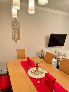 a dining room with a table with a red table cloth at Sea view Penthouse (YooBulgaria) in Obzor