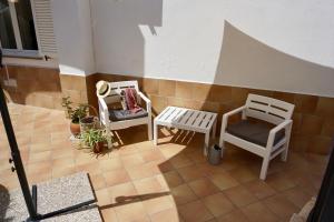 a balcony with two chairs and a table at Gloria House in Ischia Town