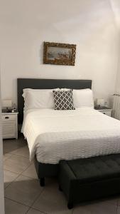 a bedroom with a bed with a black and white comforter at La Terrazza Vercelli Bed & Charme in Vercelli