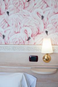 Postel nebo postele na pokoji v ubytování Hotel Flamingo
