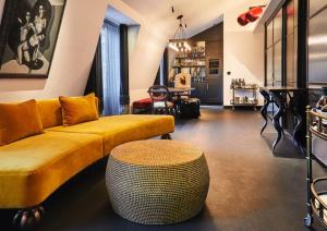 a living room with a yellow couch and a table at Chateau Denmark London in London