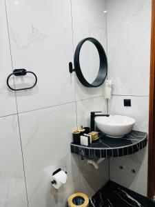 a bathroom with a sink and a mirror at Hotel Paradise Ouranoupolis in Ouranoupoli