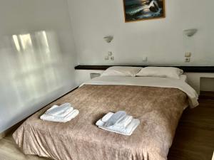 a bed with two towels on top of it at Hotel Paradise Ouranoupolis in Ouranoupoli